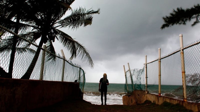 A woman looks at heavy surf as Hurricane Irma approaches Puerto Rico in Luquillo, on September 6, 2017.
Irma is expected to reach the Virgin Islands and Puerto Rico by nightfall on September 6.