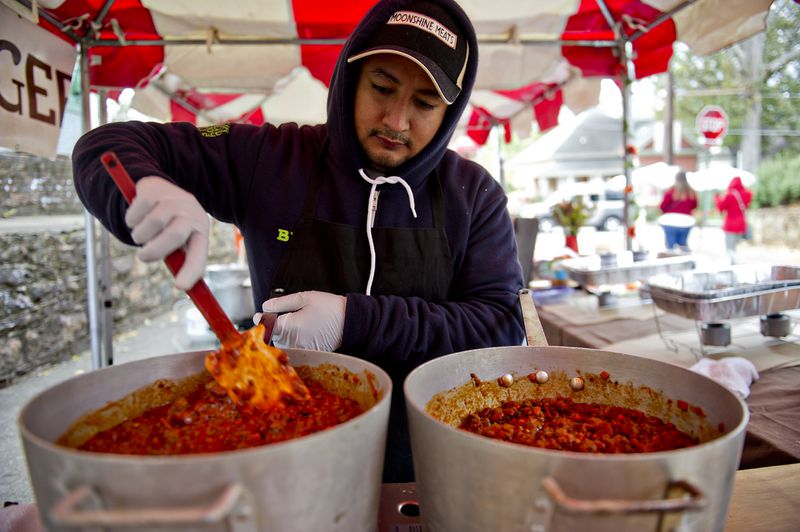 Rogelio Nino stirs vats of chili during the 12th annual Cabbagetown Chomp & Stomp in Atlanta on Saturday, November 1, 2014. The one day festival attracts tens of thousands of people to taste chili, look at art, listen to music and celebrate the historic neighborhood. JONATHAN PHILLIPS / SPECIAL