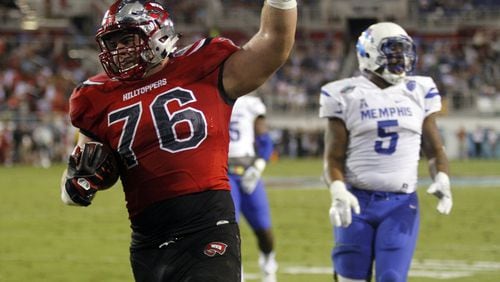 FILE - This Dec. 20, 2016, file photo shows Western Kentucky offensive lineman Forrest Lamp scoring a touchdown against Memphis during the Boca Raton Bowl NCAA college football game in Boca Raton, Fla. NFL scouts love Lamp, but his frame and arm length suggest more guard than tackle. If he was a sure-thing tackle he would probably be a top-10 pick. Instead, middle of the first.(Adam Sacasa/South Florida Sun-Sentinel via AP)
