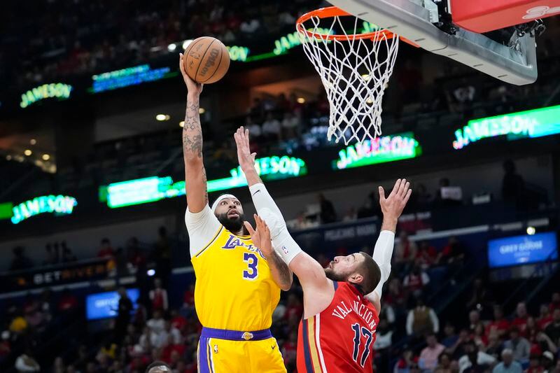 Los Angeles Lakers forward Anthony Davis (3) shoots against New Orleans Pelicans center Jonas Valanciunas (17) in the first half of an NBA basketball play-in tournament game Tuesday, April 16, 2024, in New Orleans. (AP Photo/Gerald Herbert)