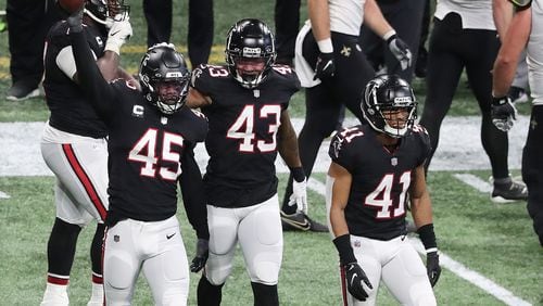 120620 ATLANTA: Atlanta Falcons Deion Jones (from left) comes up with the fumble recovery by Saints quarterback Taysom Hill with Mykal Walker and Sharrod Neasman during the 4th quarter in a NFL football game on Sunday, Dec. 6, 2020, in Atlanta.  “Curtis Compton / Curtis.Compton@ajc.com”