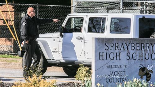 A school resource officer is posted outside of Sprayberry High School in 2020. (JOHN SPINK / AJC)