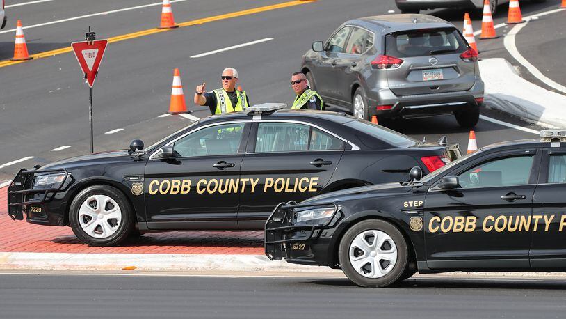 Cobb Police Department officers work traffic control at the intersection of Spring Road and Circle 75 Parkway outside  SunTrust  Park.  Curtis Compton/ccompton@ajc.com