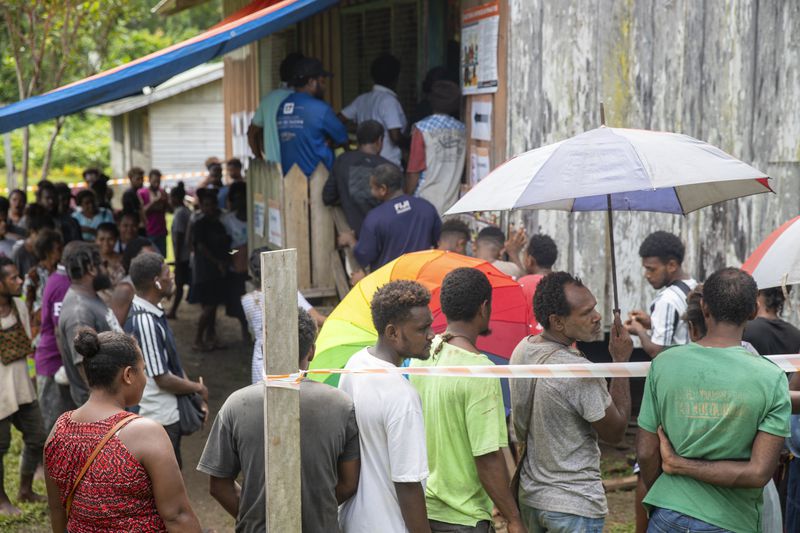 Villagers queue to vote during the Solomon Islands elections in a village on the island of San Cristobal, Wednesday, April 17, 2024. Voting has closed across Solomon Islands on Wednesday in the South Pacific nation's first general election since the government switched diplomatic allegiances from Taiwan to Beijing and struck a secret security pact that has raised fears of the Chinese navy gaining a foothold in the region. (AP Photo/Charley Piringi)