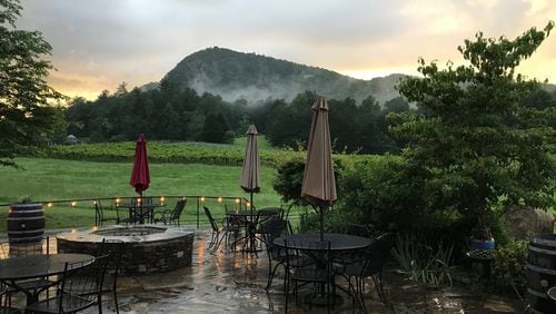 A view from the patio at Red Barn Cafe. “The night I dined there,					it rained,” writes AJC dining editor Ligaya Figueras. “Eyeing					beyond the double barn doors to lush hillside, the night falling					and white steam rising — it was perfect.” LIGAYA FIGUERAS /					LFIGUERAS@AJC.COM