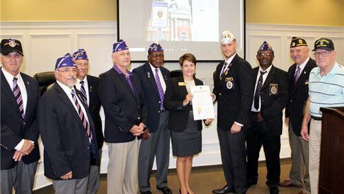 Snellville Mayor Pro Tem Barbara Bender presents the proclamation to Purple Heart Medal recipients. Courtesy City of Snellville