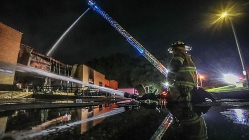 Crews with the South Fulton Fire and Rescue Department aggressively attacked a fire in the Atlanta Custom Ironworks warehouse early Tuesday morning. The building houses oxygen and propane cannisters, as well as painting materials, fire Lt. Eric Jackson said. The cause of the fire remains under investigation.