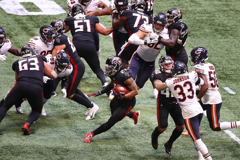 Falcons running back Todd Gurley finds a hole through the Chicago Bears defense on a touchdown run to give Atlanta a 23-10 lead during the third quarter Sunday, Sept. 27, 2020, at Mercedes-Benz Stadium in Atlanta.  (Curtis Compton / Curtis.Compton@ajc.com)