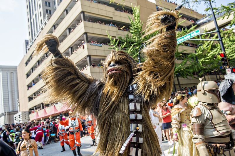 Dressed as Chewbacca, Matt Pfingsten throws his hands into the air during the annual Dragon Con Parade in Atlanta on Sept. 5, 2015. JONATHAN PHILLIPS / SPECIAL