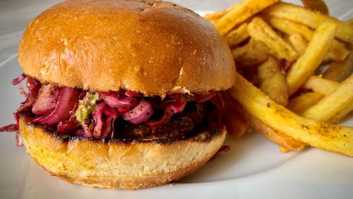 The spiced lamb burger with fries is available from Rina, an Israeli restaurant in Atlanta's Old Fourth Ward. Henri Hollis/henri.hollis@ajc.com