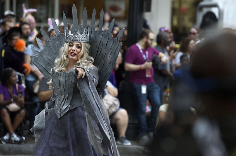 A cosplayer dressed as Cersei Lannister, the queen regent on "Game of Thrones," points at the crowd as she walks down Peachtree Street at the annual Dragon Con Parade on Saturday, Sept. 1, 2018, in Atlanta. (Photo: Jenna Eason / Jenna.Eason@coxinc.com)