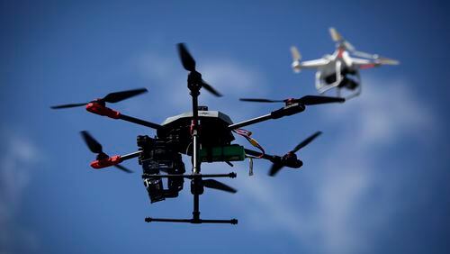 Drones fly in the sky outside Hacklab in Boynton Beach during International Drone Day activities March 14, 2015. (Bruce R. Bennett / The Palm Beach Post)