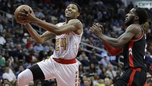 Atlanta Hawks’ Kent Bazemore, left, goes up for a shot against Toronto Raptors’ DeMarre Carroll in the second quarter of an NBA basketball game in Atlanta, Friday, March 10, 2017. (AP Photo/David Goldman)