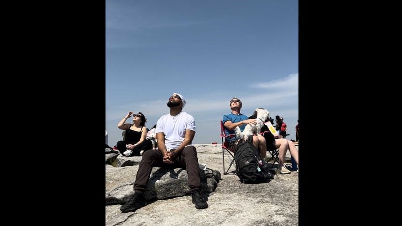 Several people watched Monday's solar eclipse from the top of Stone Mountain. (Jessica Horne / jessica.horne@ajc.com).