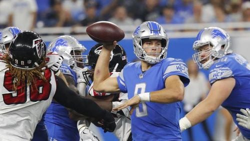Detroit Lions quarterback Matthew Stafford (9), pressured by Atlanta Falcons defensive end Takkarist McKinley (98), passes during the first half of an NFL football game, Sunday, Sept. 24, 2017, in Detroit. (AP Photo/Paul Sancya)