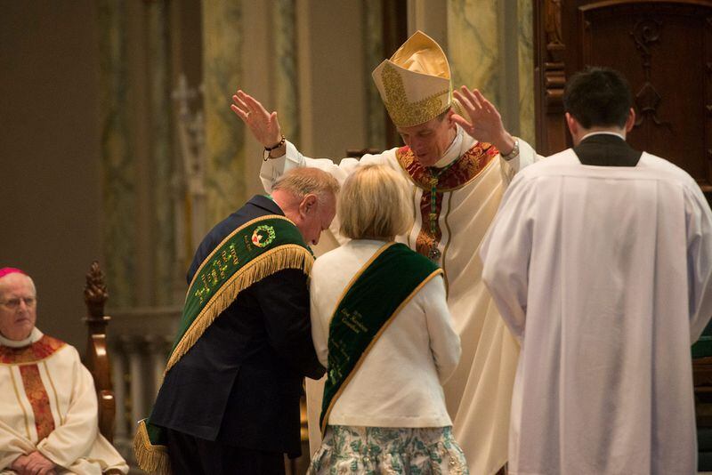 Most Reverend Bishop Stephen D. Parkes blesses St. Patrick's Day Parade Committee Grand Marshal George Schwarz III and his wife Patricia Hodges Schwarz at Cathedral Basilica of St. John the Baptist's St. Patrick's Day Mass.
