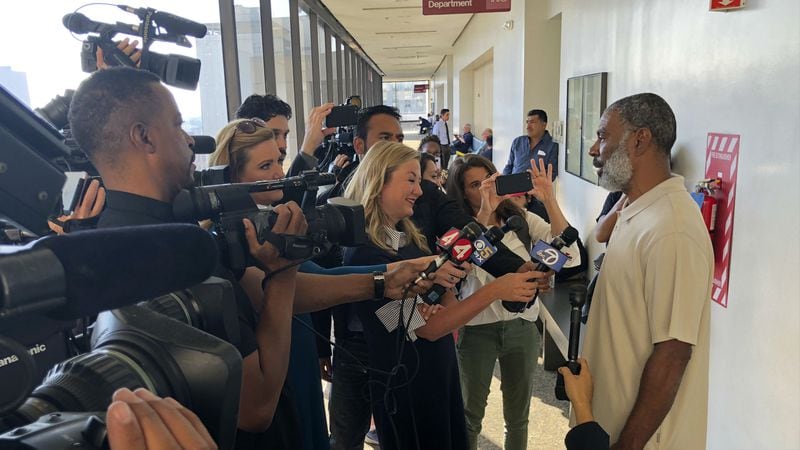 Ansar Muhammad, father of 18-year-old Nia Wilson, who was fatally stabbed at a Bay Area Rapid Transit station, talks with reporters outside a courtroom before the arraignment of suspect John Lee Cowell Wednesday, July 25, 2018, in Oakland, California. Wilson's older sister, Lehtifa Wilson, was also stabbed, but survived.