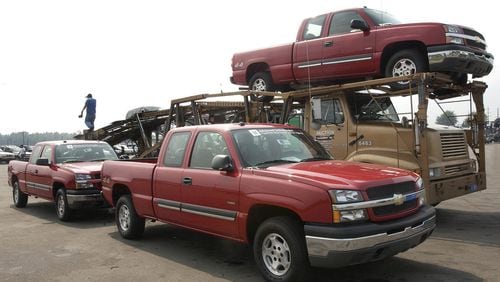 Trucks are loaded at Manheim’s Detroit Auto Auction in 2004. Manheim is part of Cox Automotive. (General Motors/Joe Polimeni)