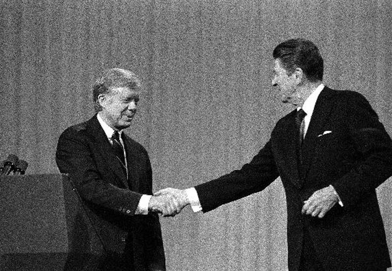 In this Oct. 28, 1980 file photo, President Jimmy Carter shakes hands with Republican Presidential candidate Ronald Reagan after debating in the Cleveland Music Hall in Cleveland. AP file photo/Madeline Drexler