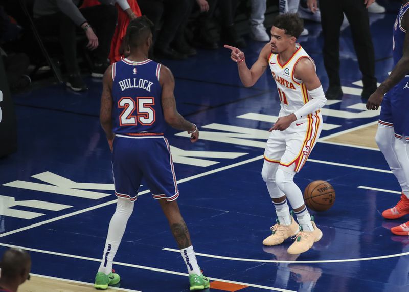 Atlanta Hawks guard Trae Young (11) points to New York Knicks forward Reggie Bullock (25) after scoring in the first quarter of Game 5 of an NBA basketball first-round playoff series Wednesday, June 2, 2021, in New York. (Wendell Cruz/Pool Photo via AP)