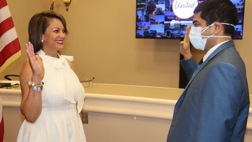 Rusi Patel, general counsel for the Georgia Municipal Association, installs Marietta City Councilwoman Michelle Cooper Kelly as the association’s third vice president on Thursday, July 2.
