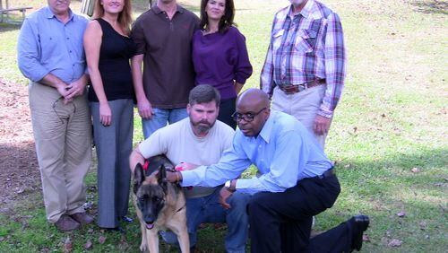 Will Chase (far right, petting dog), a veteran and founder of Please Find My Dog, with his partners trying to save dogs and stem the tide of suicides among veterans. Left to right, partner Skip Cloninger, Danielle Tynan of Passion for Paws, Marcus Whitesides and Lora Wissman of All About Veterans, Loren Cook of VFW-Sandy Springs, Michael Adair and Gypsy.