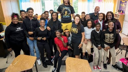 Atlanta Public Schools' Districtwide Teacher of the Year Mahoganey Jackson is surrounded by Superintendent Meria Carstarphen and others, including members of the teacher's eighth grade class at Sylvan Hills Middle School.   Photo courtesy of  Ben Dashwood, Raftermen Photography