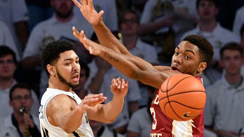 Georgia Tech guard Josh Heath, left, passes as Florida State guard Trent Forrest (3) defends during the first half of an NCAA basketball game, Wednesday, Jan. 25, 2017, in Atlanta. (AP Photo/John Amis)