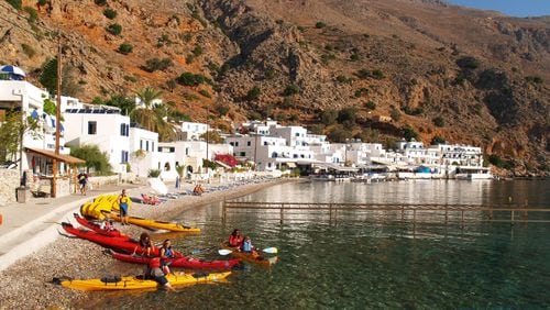 Kayakers on a Northwest Passage trip get ready to depart for a day’s paddle from Loutro in Crete. (Northwest Passage)