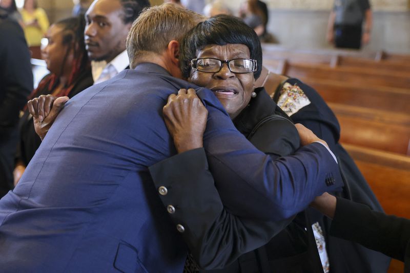 Lutricia Henderson Gray, facing, hugs Michael Holmes after murder charges were dropped against Clarence Henderson, Lutricia’s father, in a historic court hearing at the Carroll County Courthouse, Thursday, March 2, 2023, in Carrollton, Ga. Michael Holmes is the cousin of victim Carl “Buddy” Stevens, Jr.. Jason Getz / Jason.Getz@ajc.com)