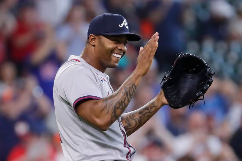 Atlanta Braves closing pitcher Raisel Iglesias celebrates after a baseball game against the Houston Astros, Wednesday, April 17, 2024, in Houston. The Braves won 5-4 in 10 innings. (AP Photo/Michael Wyke)