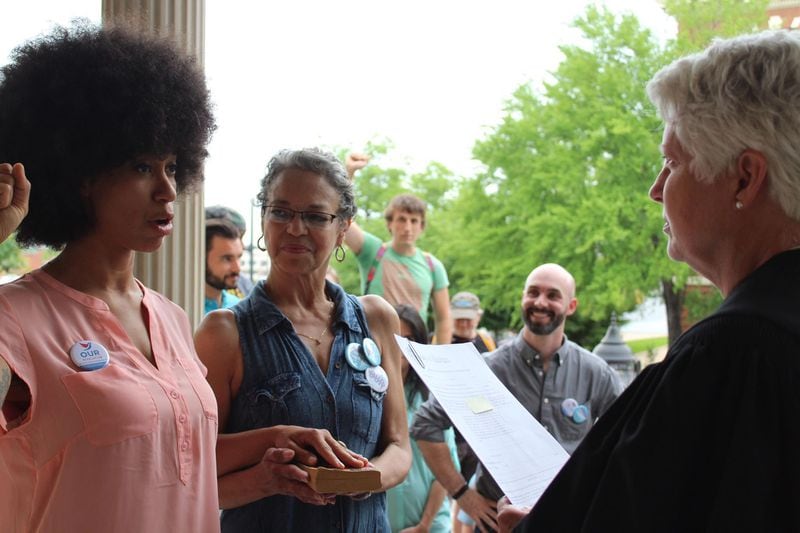 Mariah Parker was sworn in as Athens-Clarke County Commissioner on Monday while putting her hand on "The Autobiography of Malcolm X." (Raphaëla Aleman)