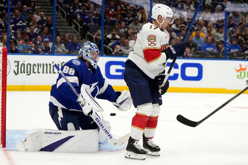 Tampa Bay Lightning goaltender Andrei Vasilevskiy (88) makes a save on a deflection by Florida Panthers center Evan Rodrigues (17) during the first period in Game 3 of an NHL hockey Stanley Cup first-round playoff series, Thursday, April 25, 2024, in Tampa, Fla. (AP Photo/Chris O'Meara)