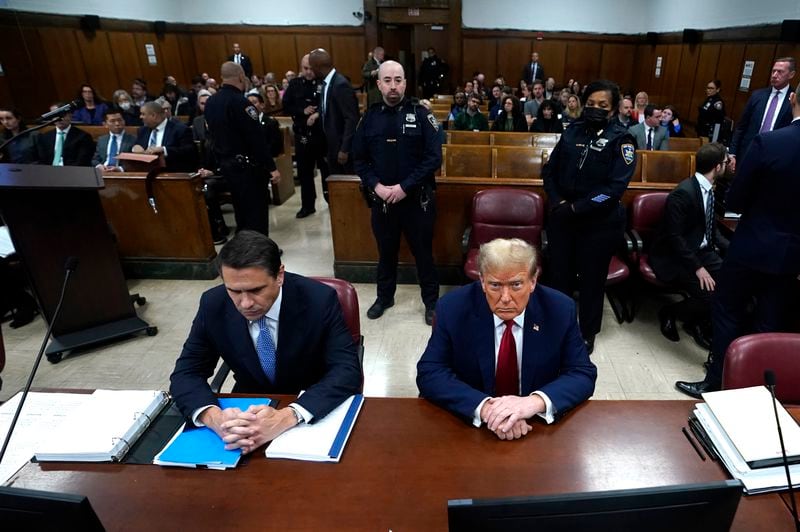 Former US President Donald Trump, right, sitting next to lawyer Todd Blanche, attends his trial for allegedly covering up hush money payments linked to extramarital affairs, at Manhattan Criminal Court in New York City, Tuesday April 23, 2024. Before testimony resumes Tuesday, the judge will hold a hearing on prosecutors' request to sanction and fine Trump over social media posts they say violate a gag order prohibiting him from attacking key witnesses. (Timothy A. Clary/Pool via AP)
