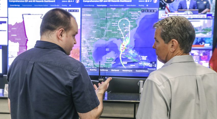 State Meteorologist Will Lanxton (left) explains the latest hurricane projections with Governor, Brian Kemp (right). Gov. Brian Kemp touring the GEMA facility on Wednesday, Sept. 28, 2022 urged Georgians to take caution as Hurricane Ian gains intensity off the western coast of Florida, threatening to bring torrential rain, dangerous storm surges and sweeping winds to the state this week.  (John Spink / John.Spink@ajc.com)


