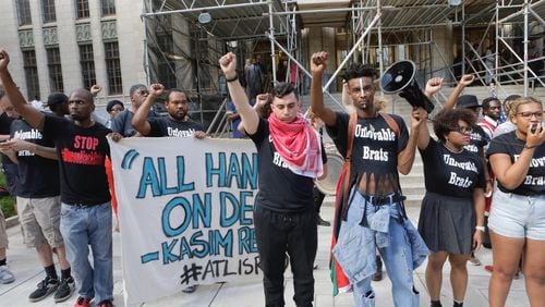 Black Lives Matter protesters outside of Atlanta City Hall chant while displaying a banner reading "All hands on deck -- Kasim Reed." The banner refers to a June 29 press conference in which Mayor Reed said of his plan to reduce crime in the city, "As mayor of the city of Atlanta, public safety is my No. 1 priority. It's a vigorous and detailed plan, but it can be simply summed up: It's all hands on deck."
