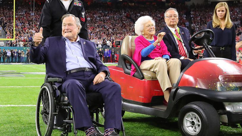 Former President George H.W. Bush gives the cheering crowd a thumbs up and former First Lady Barbara Bush waves as they take the field for the coin toss while the Atlanta Falcons meet the New England Patriots in Super Bowl LI at NRG Stadium in Houston, TX, Sunday,  February 5, 2017. Curtis Compton/AJC