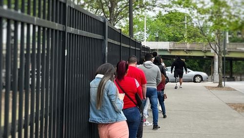 Migrants wait in line to check in at the Atlanta ICE Field Office on Tuesday, April 16, 2024. (Lautaro Grinspan)