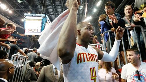 Paul Millsap celebrates a 116-98 victory over the Wizards with fans in Game 3 of a first-round NBA basketball playoff series on Saturday, April 22, 2017, in Atlanta. Curtis Compton/ccompton@ajc.com