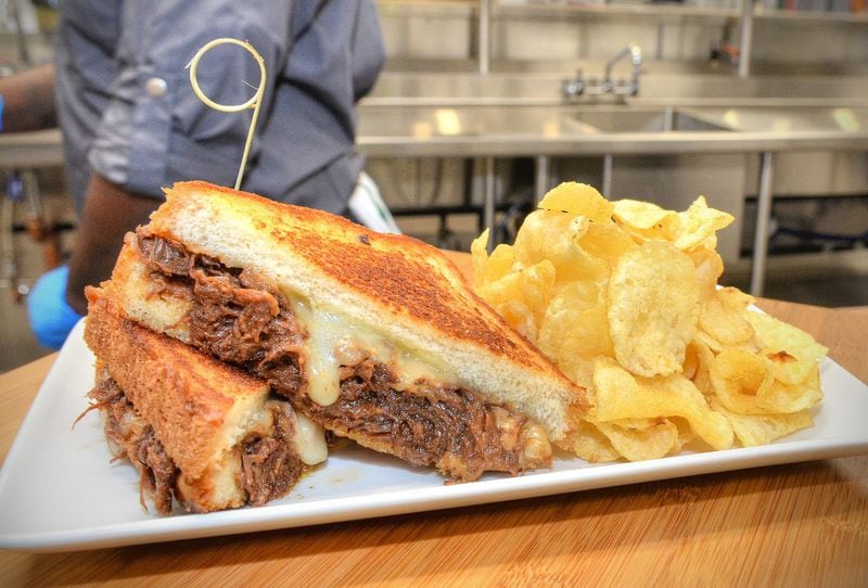 Looking for more than a burger at your next Falcons game at the new Mercedes-Benz Stadium? A brisket grilled cheese, with braised beef, barbecue aioli and fontina cheese on Texas toast, plus a side of kettle chips, will be served at Hot Press Express portable carts in sections 104, 226 and 307. CHRIS HUNT / SPECIAL