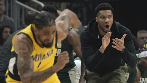 Milwaukee Bucks' Giannis Antetokounmpo reacts from the bench during the first half of Game 1 of the NBA playoff basketball game Sunday, April 21, 2024, in Milwaukee. (AP Photo/Morry Gash)