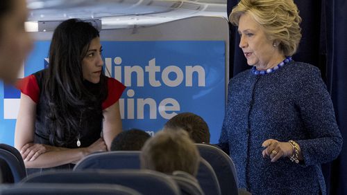 Democratic presidential candidate Hillary Clinton speaks with senior aide Huma Abedin aboard her campaign plane at Westchester County Airport in White Plains, N.Y., Friday, Oct. 28, 2016, before traveling to Iowa for rallies. (AP Photo/Andrew Harnik)