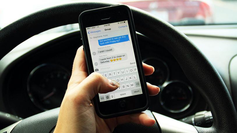 Texting while operating a vehicle can distract a driver. Photo illustration by LAUREN OLSON