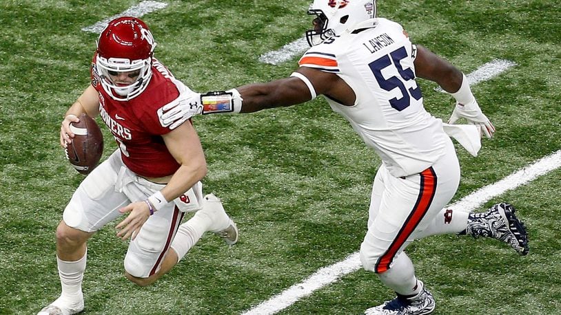 Baker Mayfield #6 of the Oklahoma Sooners avoids a tackle by Carl Lawson #55 of the Auburn Tigers during the Allstate Sugar Bowl at the Mercedes-Benz Superdome on January 2, 2017 in New Orleans, Louisiana.