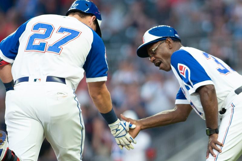 Atlanta Braves third base coach Ron Washington (37) celebrates with Austin Riley (27), who hit a home run against the Milwaukee Brewers during the first inning of a baseball game Friday, July 30, 2021, in Atlanta. (AP Photo/Hakim Wright Sr.)