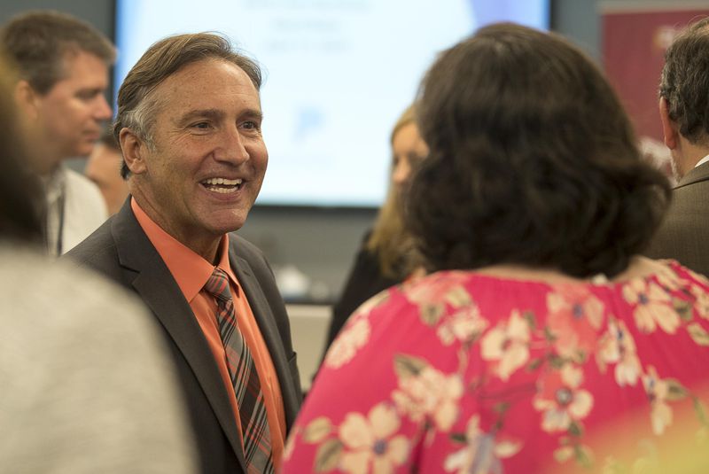 Fulton County Schools superintendent finalist Mike Looney (left) greets individuals after being announced Wednesday as the sole finalist for the job. The board will vote on his hiring May 2. (ALYSSA POINTER/ALYSSA.POINTER@AJC.COM)