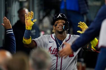 Atlanta Braves' Ronald Acuna Jr. returns to the dugout after hitting a home run during the eighth inning of a baseball game against the Los Angeles Dodgers in Los Angeles, Friday, May 3, 2024. (AP Photo/Ashley Landis)