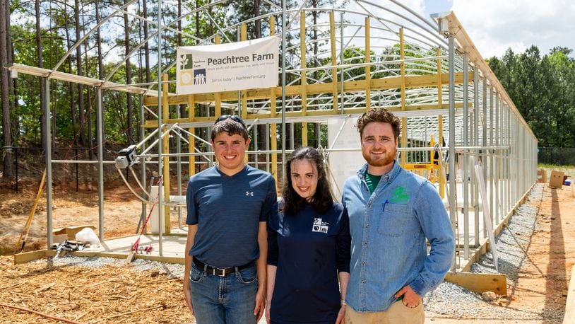 James Montesi (from left), Quinn Twiner and her brother Joe in front of the green house under construction at Peachtree Farm, a nonprofit with a mission to produce locally grown produce, products and animals for the metro Atlanta and North Georgia area wile providing job opportunities for individuals with disabilities. The farm, located in Peachtree Corners, was started by Mike and Mary Twiner. PHIL SKINNER FOR THE ATLANTA JOURNAL-CONSTITUTION.