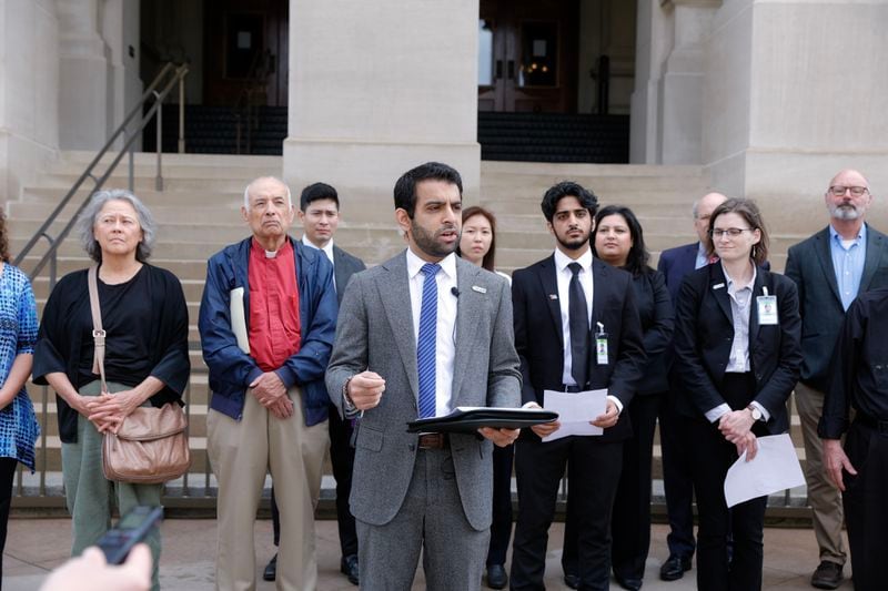 Surrounded by several groups, Murtaza Khwaja, executive director of the Georgia chapter of the Council on American-Islamic Relations (CAIR), speaks at a news conference Monday, March 27. They oppose House Bill 144, also known as the antisemitism bill. (Natrice Miller/The Atlanta Journal-Constitution)