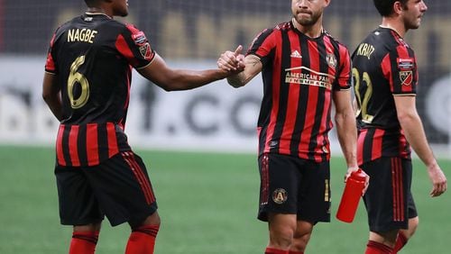 March 13, 2019 Atlanta: Atlanta United midfielder Darlington Nagbe (left) gets five from Hector Villalba as time expires against Monterrey during the second half in a Concacaf Champions league quarterfinal match on Wednesday, March 13, 2019, in Atlanta. Atlanta United won the match 1-0 but failed to advance.   Curtis Compton/ccompton@ajc.com
